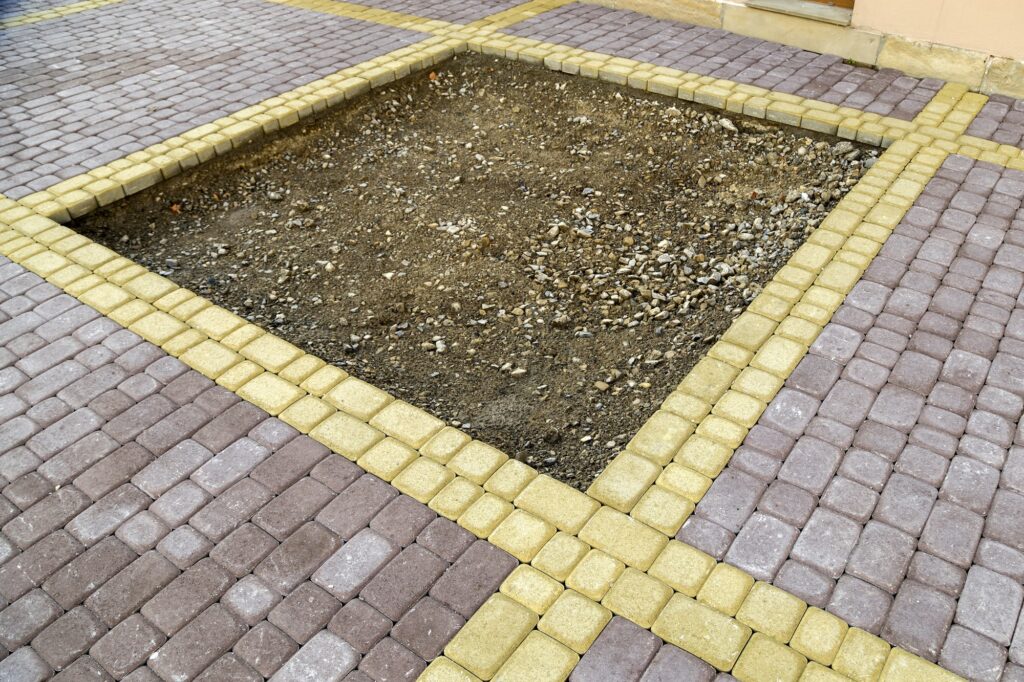 Installation of stone paving slabs in a yard.